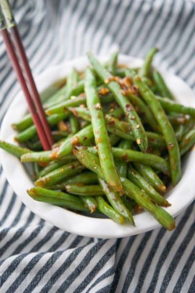 Chili Garlic Green Beans with an Asian flare are one of PF Changs most popular side dishes. Now you can make these tasty vegetables at home!