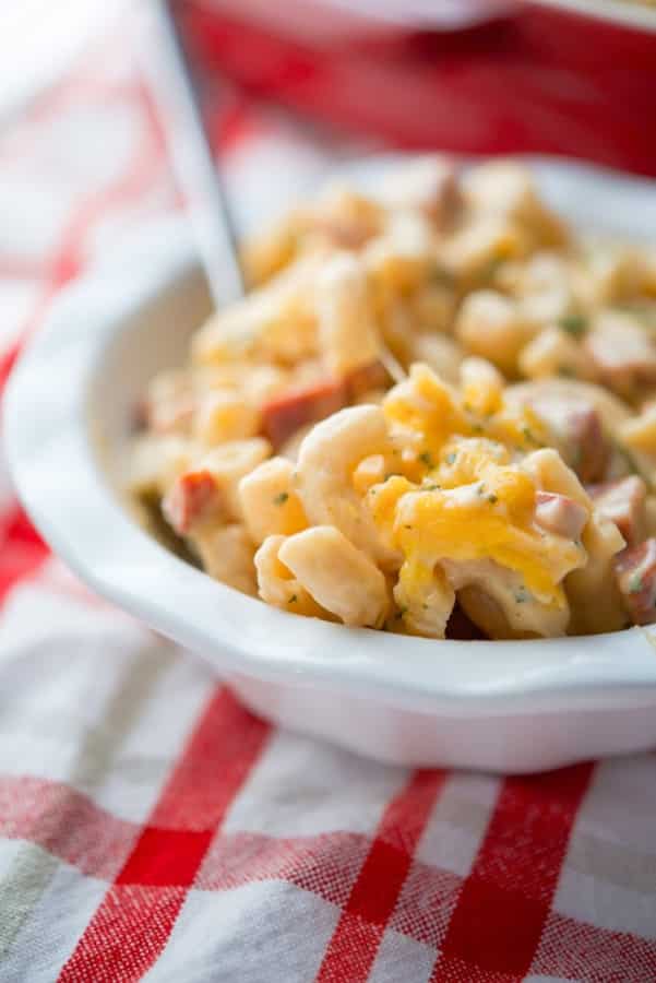 A close up of a plate of macaroni and cheese with chourico. 