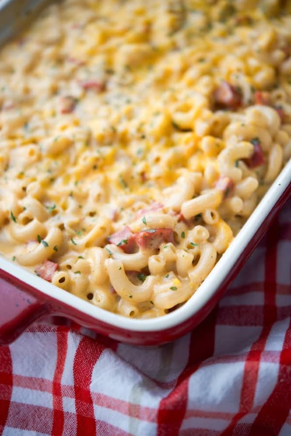 Chorizo macaroni and cheese in a red casserole dish. 