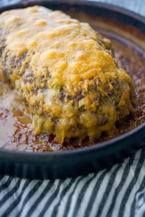 Cheesy meatloaf in a baking dish. 