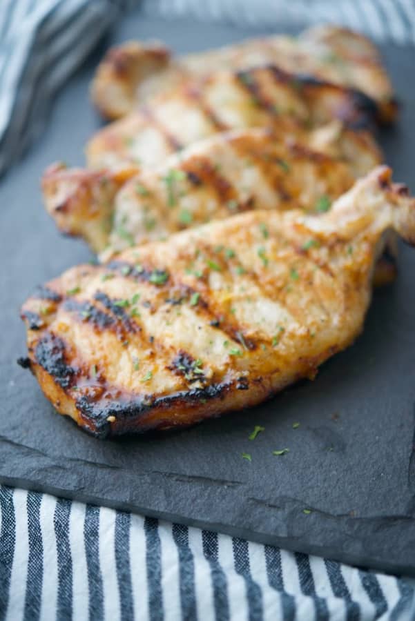 Boneless center cut pork chops marinated in a honey and roasted garlic vinaigrette; then grilled are super tender and delicious. 