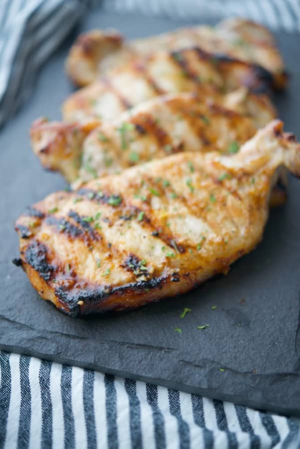 Boneless center cut pork chops marinated in a honey and roasted garlic vinaigrette; then grilled are super tender and delicious. 