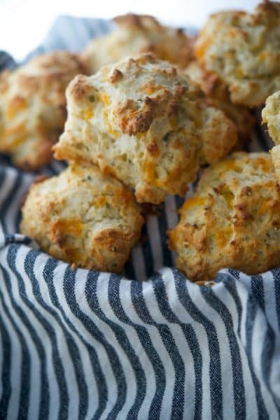 These flaky Sour Cream and Chive Drop Biscuits are so deliciously light and buttery, you'll never make homemade yeast rolls again! 