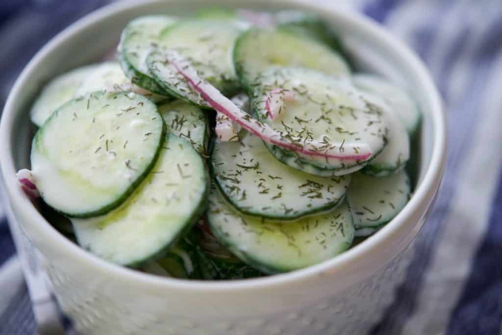 Old Fashioned Cucumber Salad in a white bowl closeup