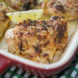 Rosemary & Lemon Roasted Chicken Thighs in red baking dish.