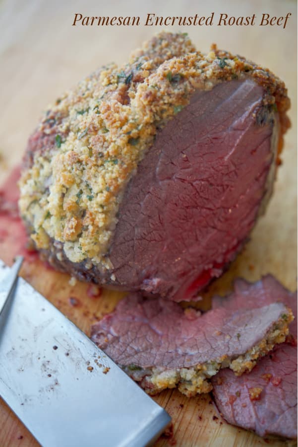A close up of Parmesan Roast Beef on a cutting board. 