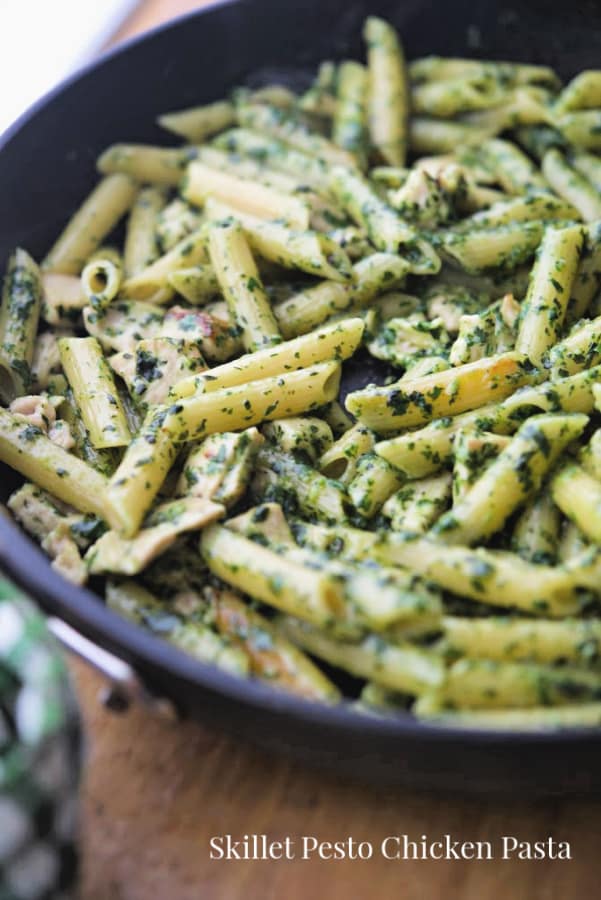 Penne pasta with boneless chicken in a homemade pesto sauce cooked in a pan. 