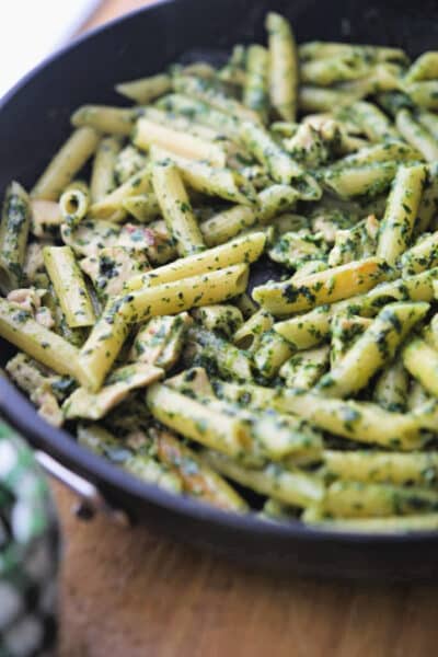 Penne pasta combined with boneless chicken in a homemade pesto sauce; then cooked on top of the stove in a skillet is a quick and easy weeknight meal.