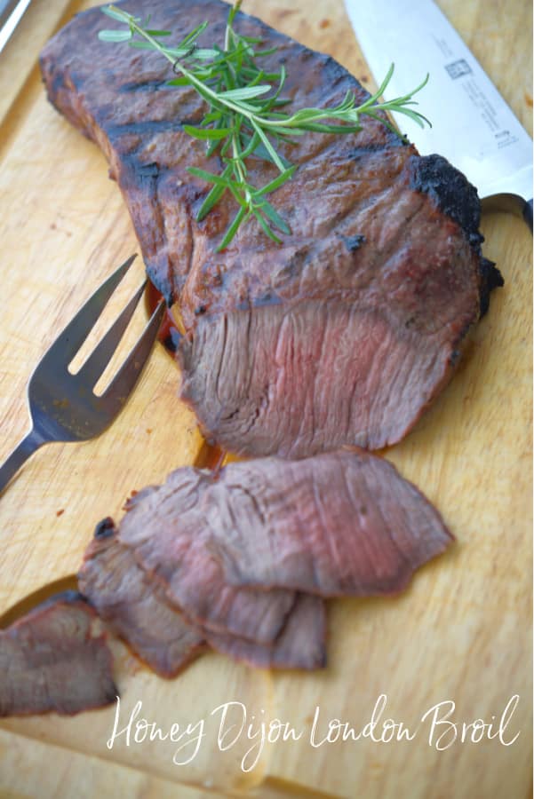 This Honey Dijon London Broil marinated in honey, Dijon mustard and fresh rosemary; then grilled is super tender and delicious. 