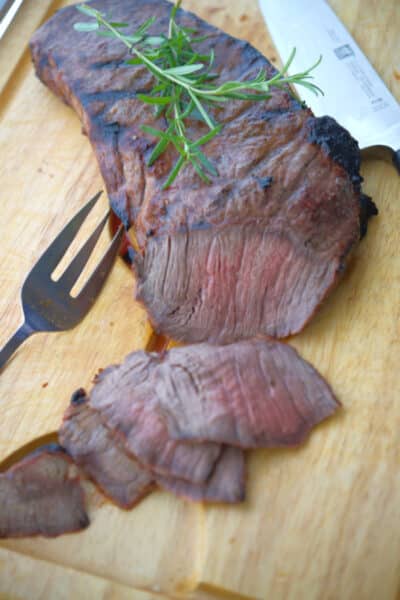 This Honey Dijon London Broil marinated in honey, Dijon mustard and fresh rosemary; then grilled is super tender and delicious. 