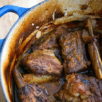 beef short ribs in a blue dutch oven