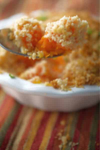 A close up of Mashed Carrot Casserole on a spoon.