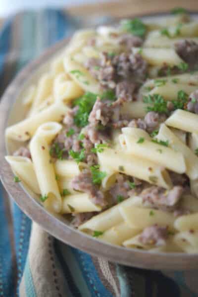 Gluten free pasta tossed with sweet Italian sausage in a mustard, white wine sage cream sauce is a delicious, quick weeknight meal.