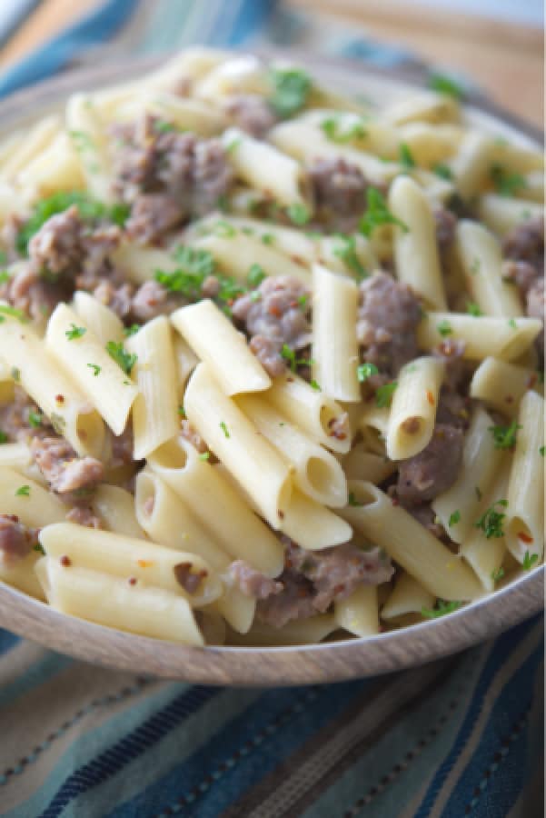 Gluten free pasta tossed with sweet Italian sausage in a mustard, white wine sage cream sauce is a delicious, quick weeknight meal.