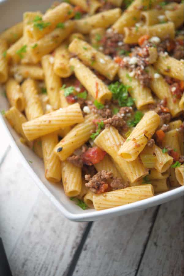 Rigatoni pasta tossed with a mirepoix of vegetables and spices in a fire roasted tomato meat sauce makes the perfect quick, weeknight meal. 