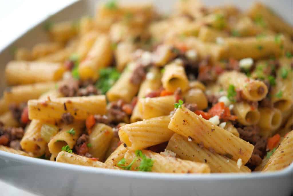 Rigatoni with Italian Meat Sauce in white bowl
