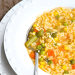 a bowl of alphabet soup with a spoon