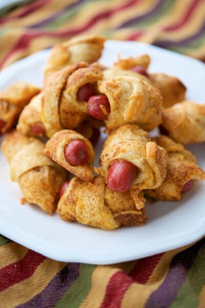 Chili Cheese Pigs in a Blanket on a white plate.