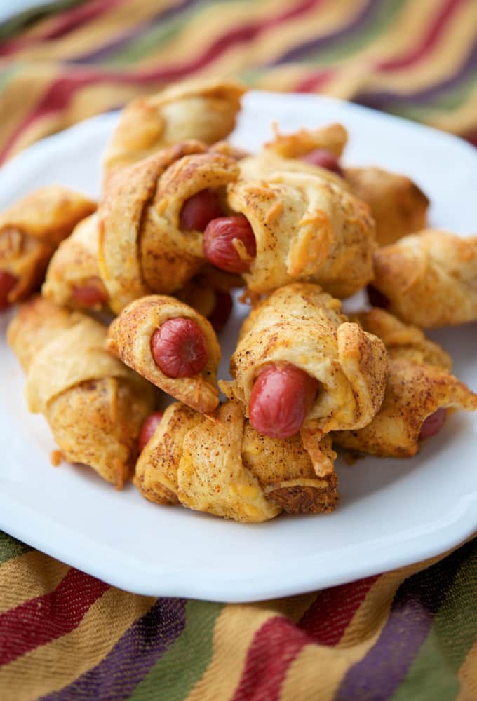 Chili Cheese Pigs in a Blanket on a white plate. 