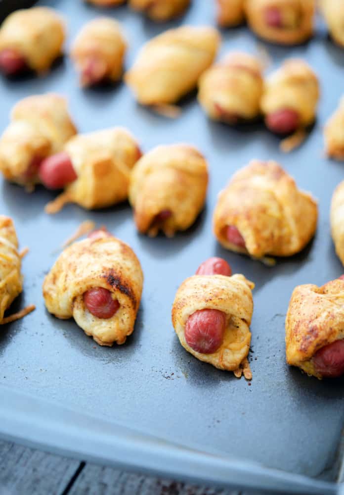 Rows of Chili Cheese Pigs in a Blanket on a slate tray