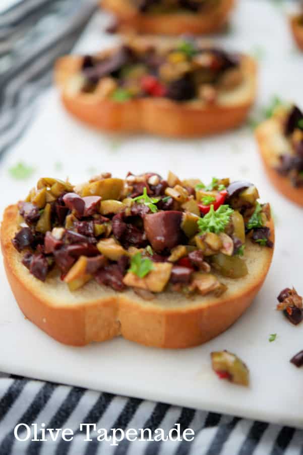 Olive Rosemary Tapenade made with a variety of olives like Kalamata, Pimento, Garlic and Sicilian on toasted bread rounds make a tasty, last minute appetizer. 