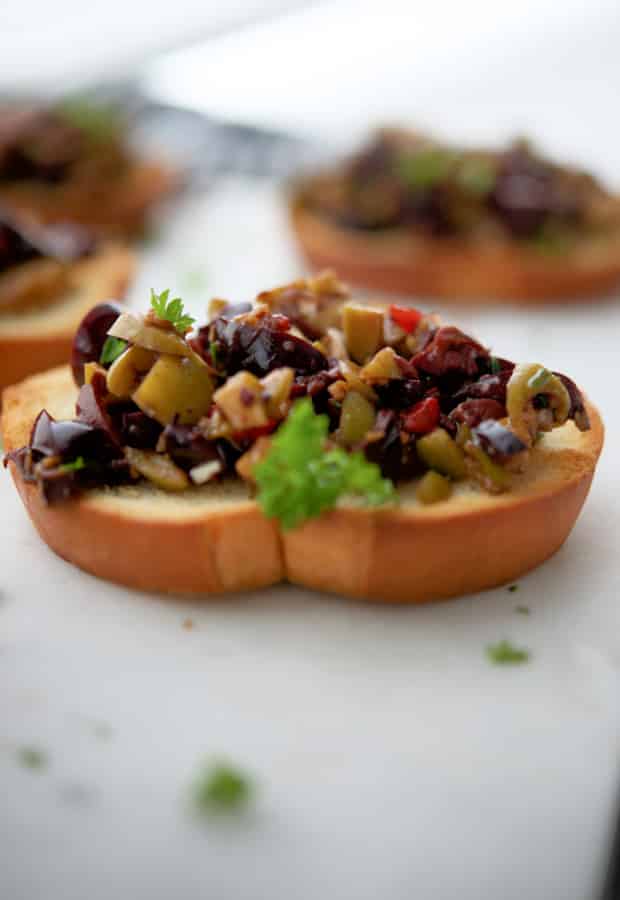 A close up of food on a plate, with Olives