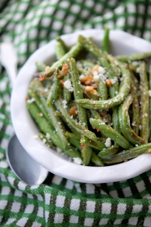 Parmesan Roasted Green Beans in a bowl on a green napkin.