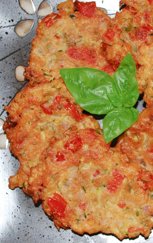 Greek Tomato Zucchini Fritters made with tomatoes, zucchini, fresh mint, basil and self rising flour, make a tasty side dish