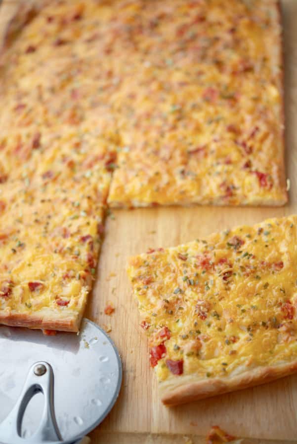 Pizza dough topped with Portuguese chourico, potatoes, tomatoes, chives, eggs and Cheddar cheese makes a tasty breakfast.