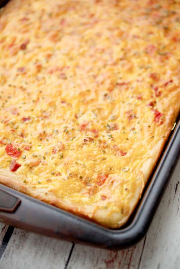 Pizza dough topped with Portuguese chourico, potatoes, tomatoes, chives, eggs and Cheddar cheese makes a tasty breakfast.