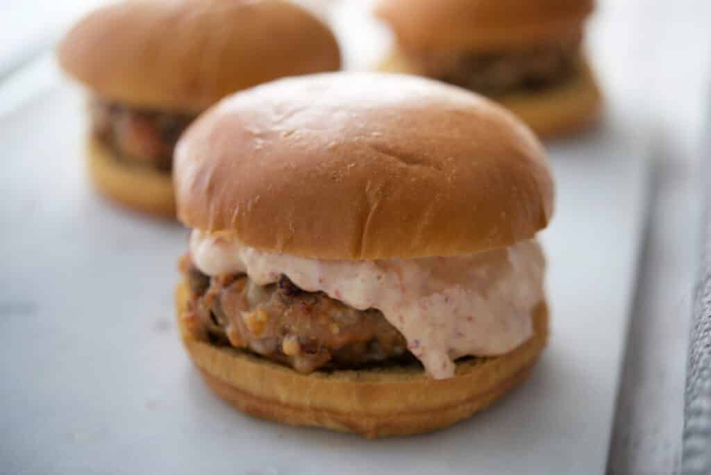 A close up of Calabrese Patties on a bun