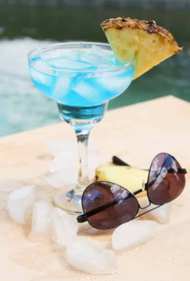 Blue White Wine Spritzer by the pool with sunglasses