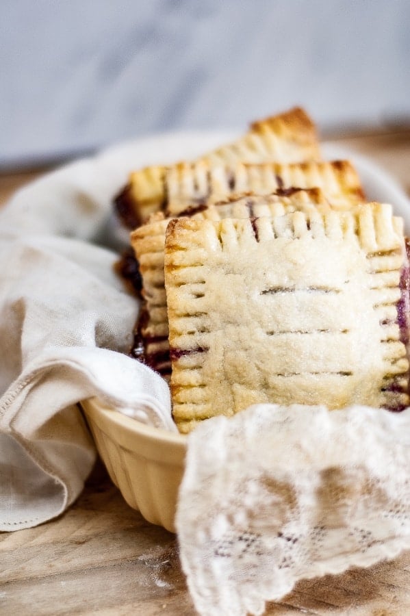 Mixed Berry Hand Pies vertical image in a basket