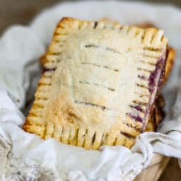 Mixed Berry Hand Pies in a basket with white napkin