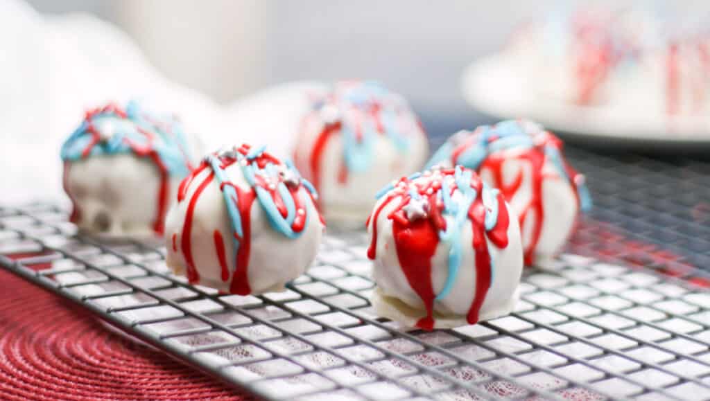 Cake balls on a cooling rack. 