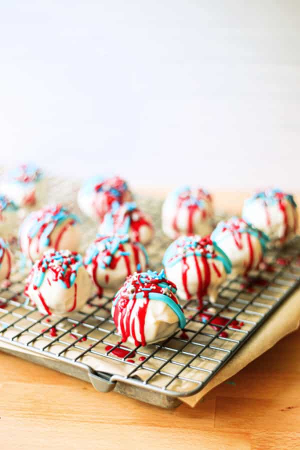 Patriotic Cake Balls on a black baking cooling rack. 