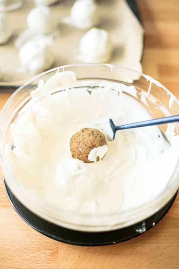 Dipping the cake balls into the melted white chocolate