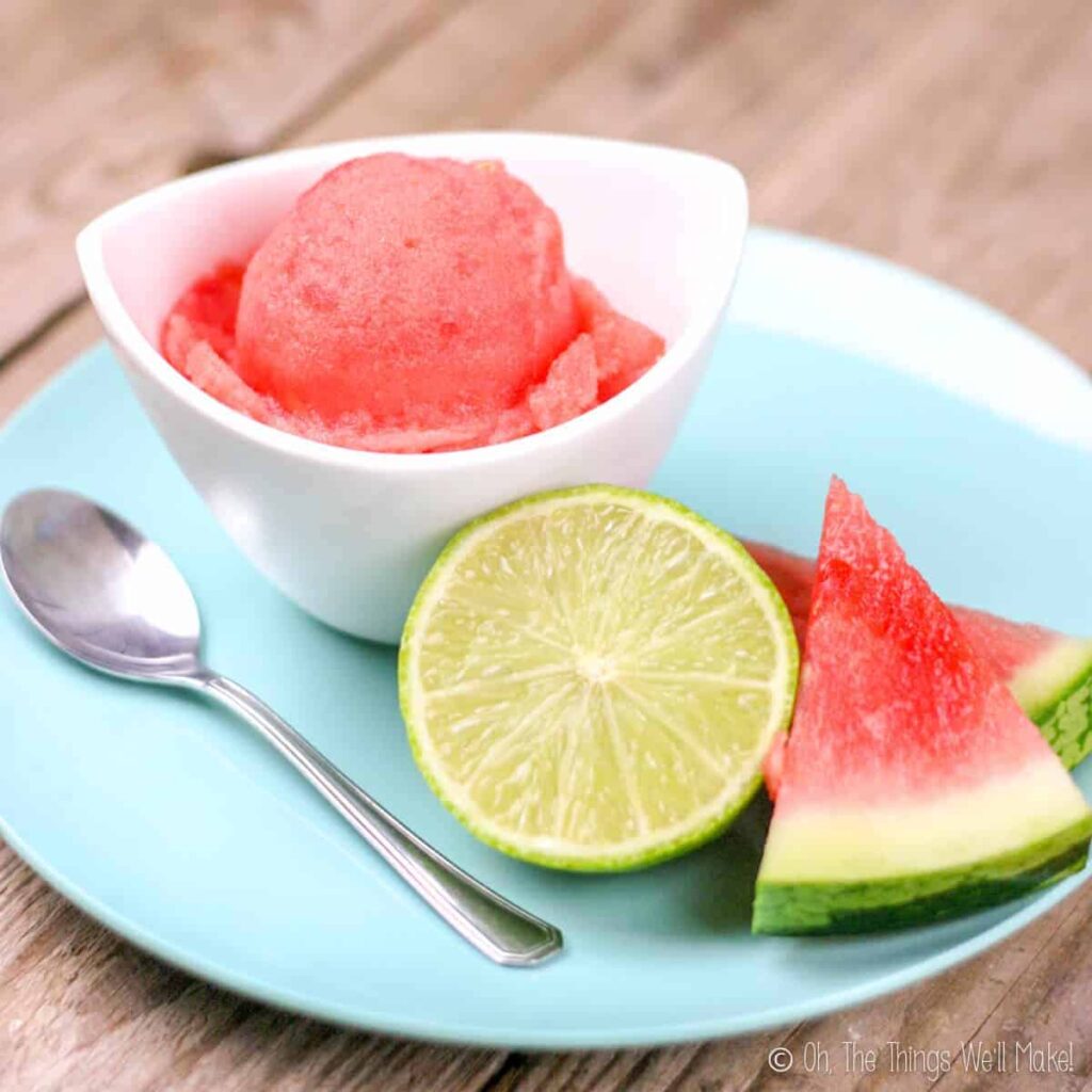 A bowl of fruit on a plate, with Watermelon and Sorbet