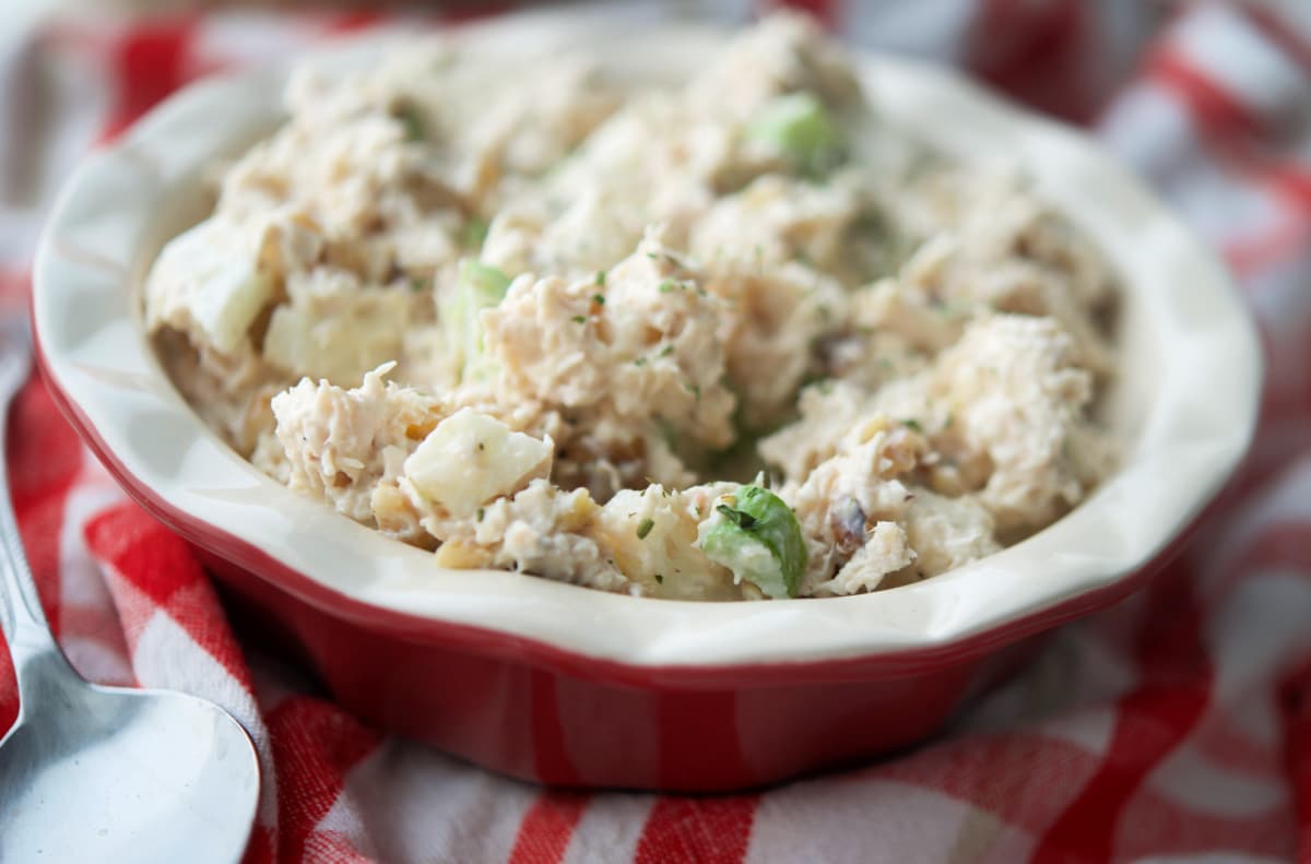 A close up of chicken salad in a red bowl