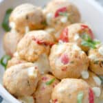 Baked Caprese Chicken Meatballs in a white casserole dish
