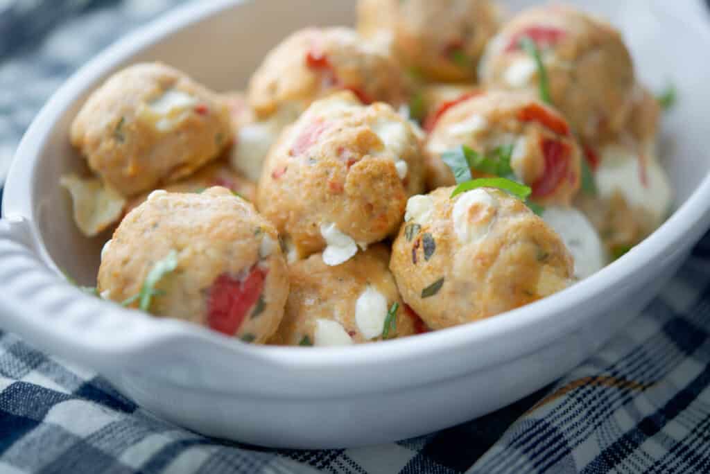 Baked Caprese Chicken Meatballs in a white dish