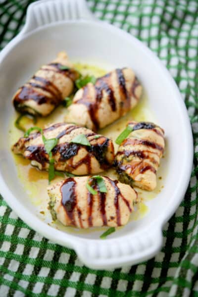 Stuffed Basil Pesto Chicken in a white dish