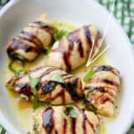 Boneless chicken breasts stuffed with fresh, homemade basil pesto; then drizzled with balsamic glaze and baked in the oven.