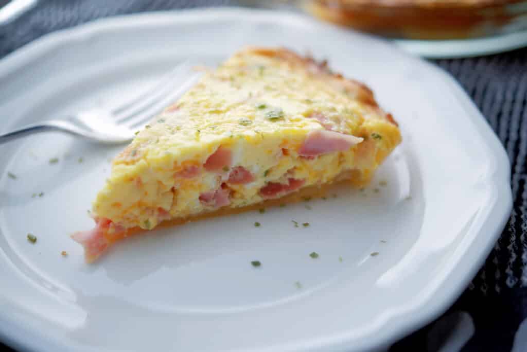 Ham and Cheese Quiche n a white plate