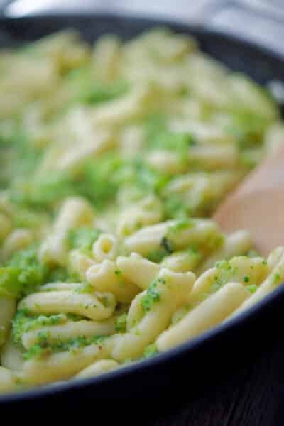 Cavatelli and Broccoli in a skillet with wooden spoon