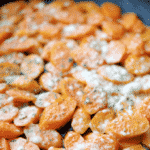 Fresh sliced carrots braised on top of the stove in some butter; then sprinkled with grated Parmesan cheese. 