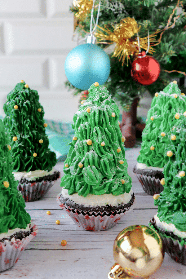 Christmas Tree Cupcakes next to a tree