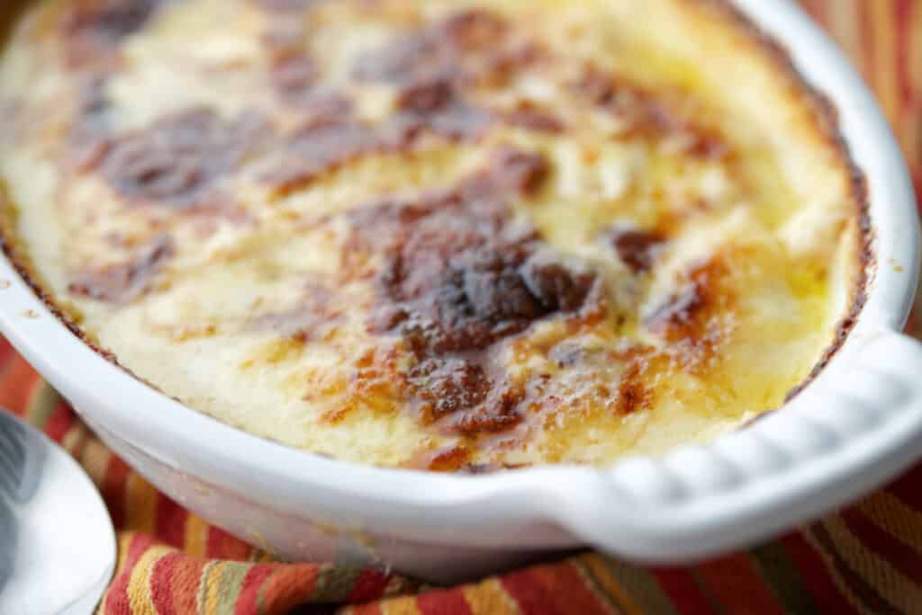 Scalloped Sweet Potatoes in a white casserole dish