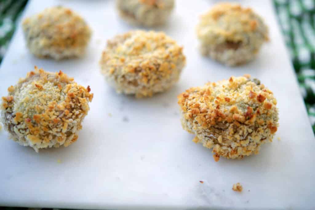 Spinach Artichoke Stuffed Mushroom on a white platter