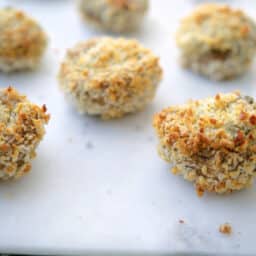 Spinach Artichoke Stuffed Mushroom on a white platter